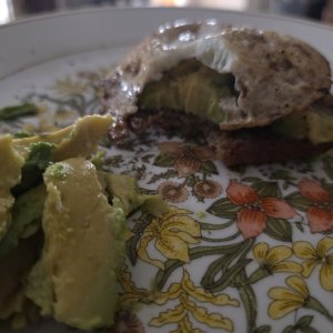 Awful photo of avocado toast and egg.