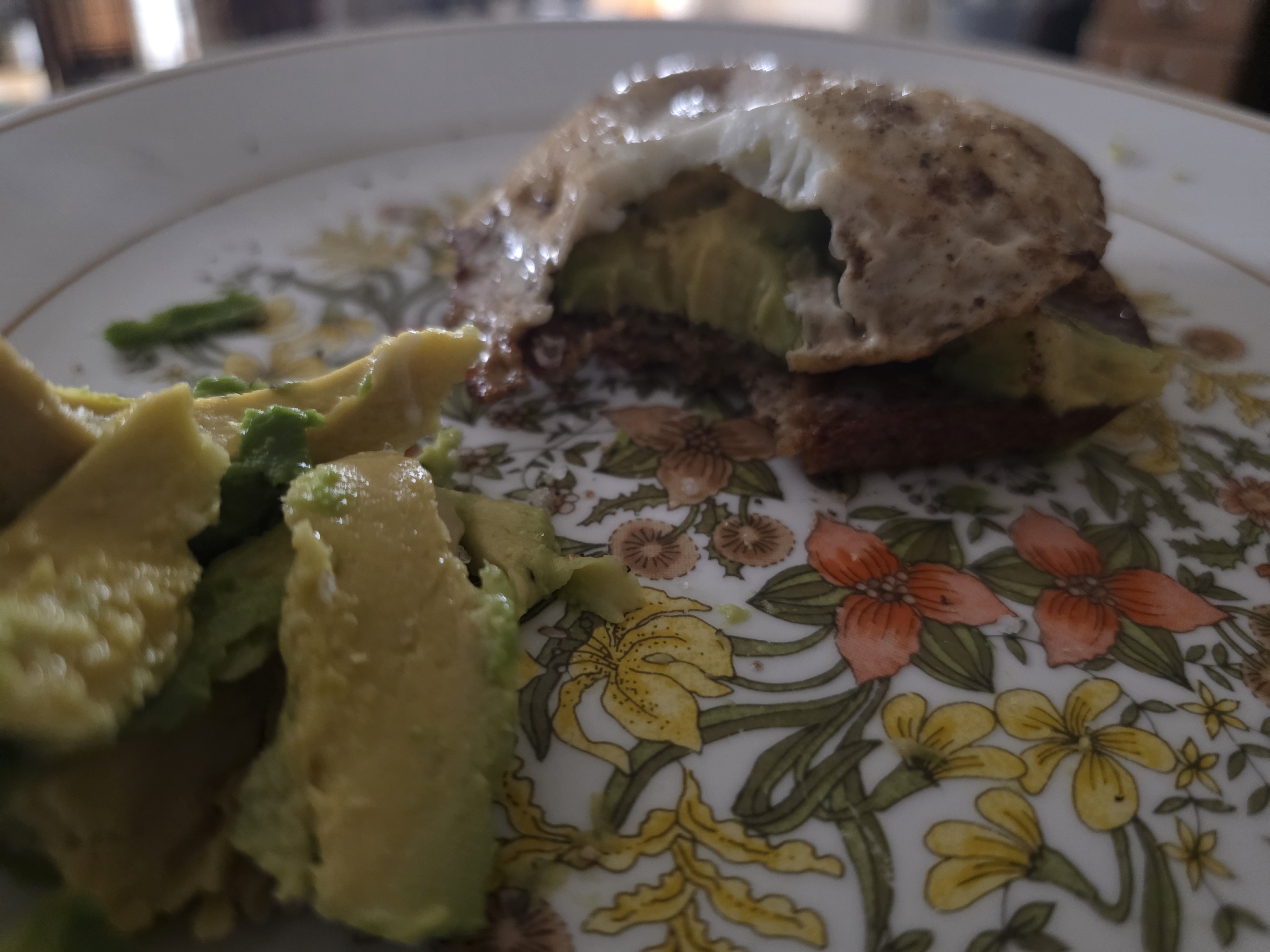 Awful photo of avocado toast and egg.
